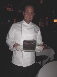 Executive Chef Dustin Rixey with the 24-layer Chocolate Cake