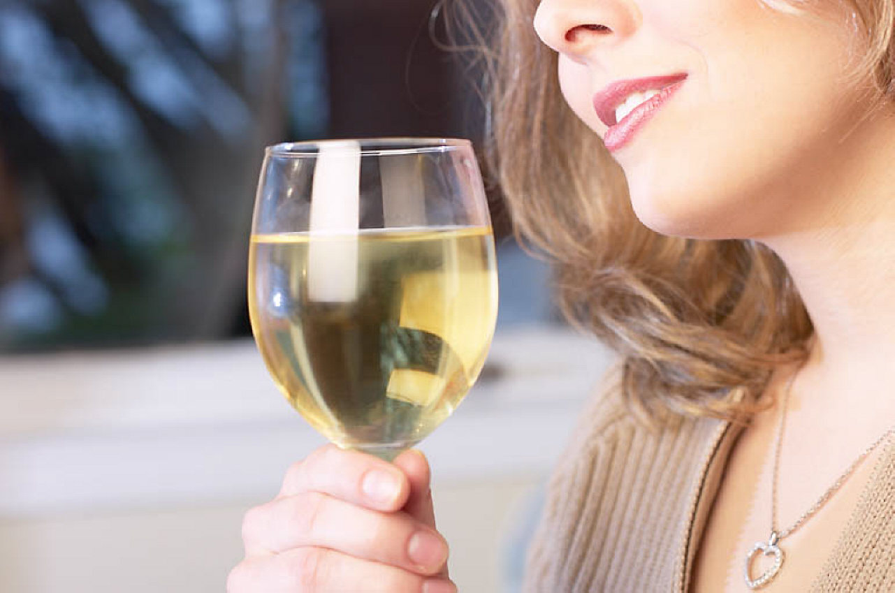 Woman drinking glass of white wine